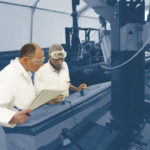 two people working with production